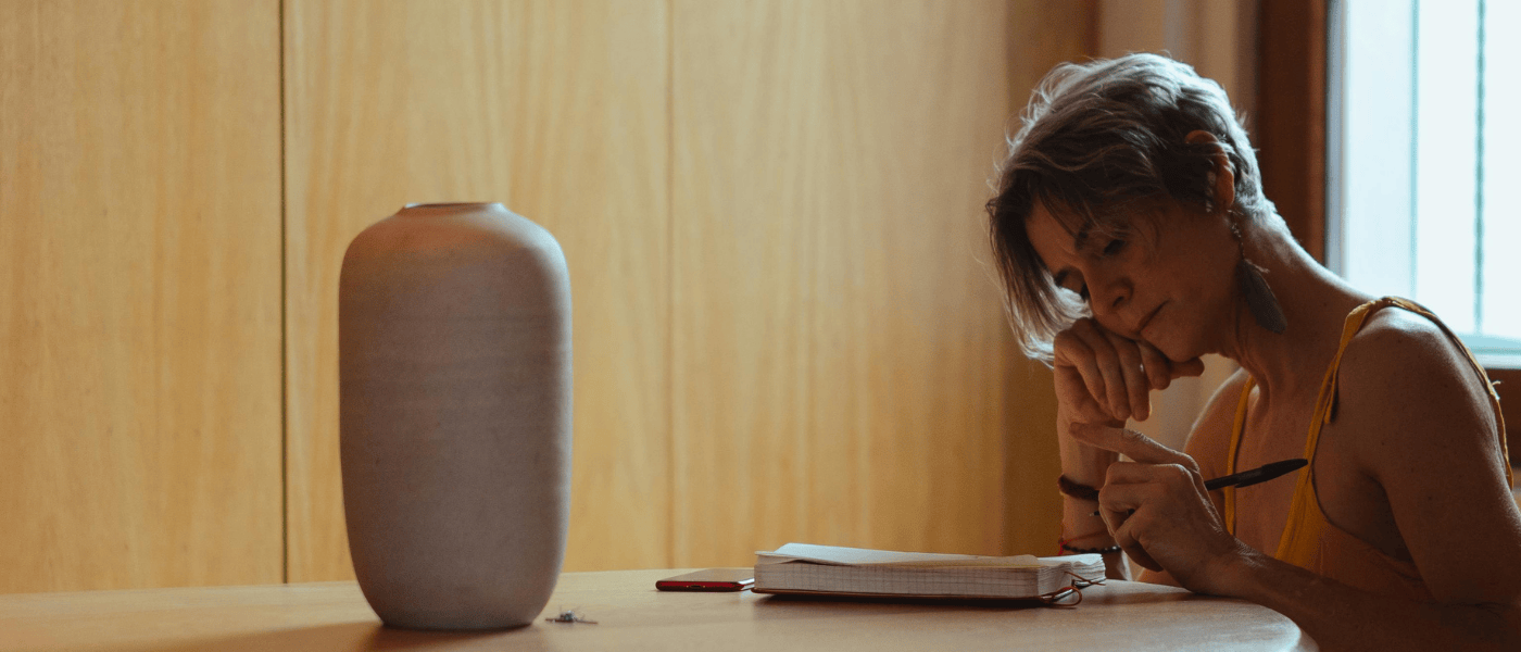 A caregiver pausing with a notebook at a quiet moment